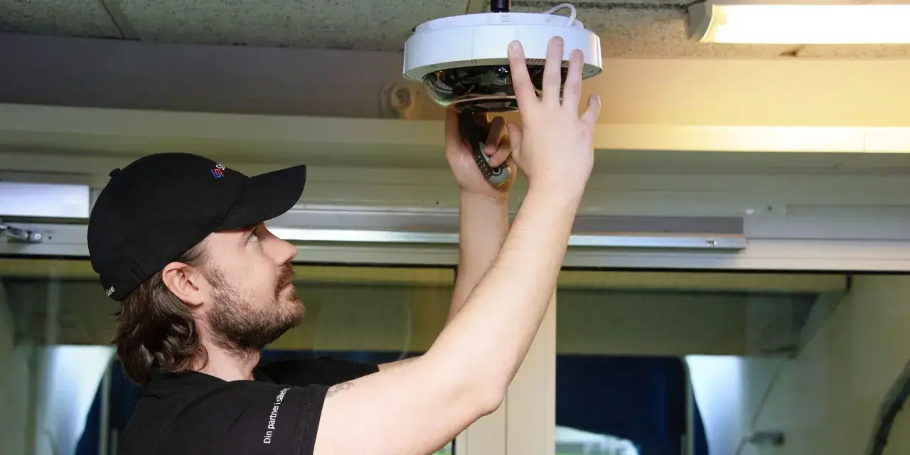 Tekniker installerar en övervakningskamera för kamerabevakning brf.