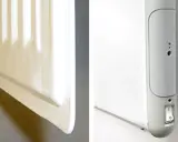 En vit radiator, en del av el element blir inte varmt. En närbild visar en strömbrytare och indikatorlampor på enheten.