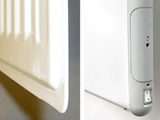 En vit radiator, en del av el element blir inte varmt. En närbild visar en strömbrytare och indikatorlampor på enheten.